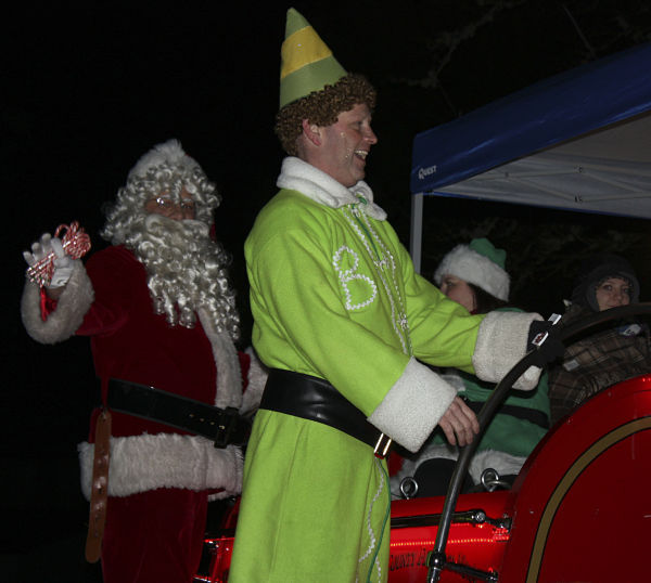 Santa (Doug Jones) and Buddy the elf (Brian Barrett) ride through the Union Hill neighborhood on Tuesday night on the back of a Redmond Firefighters Union Local 2829