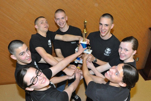 Civil Air Patrol’s Overlake Squadron color guard shows off the top award won at the state wing’s cadet competition at Camp Murray. This weekend