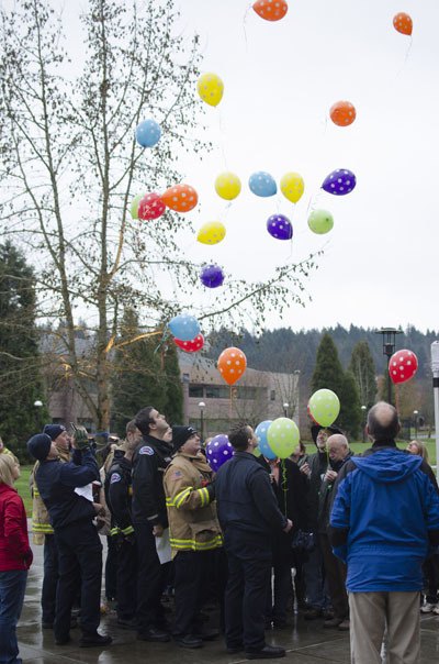 Citizens and first responders from Redmond release 26 balloons into the sky in honor of the victims of the Sandy Hook Elementary shooting in Connecticut.