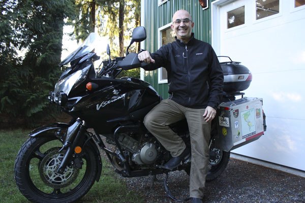 Redmond resident Pedro Castro stands beside his 2005 Suzuki V-Strom 1000