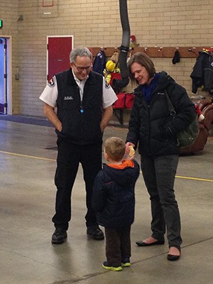 Firefighter Mike Hilley and Becky Cole talk with Becky’s son Ryan at last week’s event; Becky was pregnant with Ryan when she collapsed from cardiac arrest in 2010.