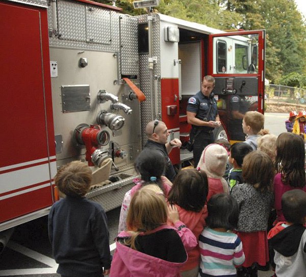 Members of the Redmond Fire Department visited with students at Montessori Children's House in Redmond on Oct. 13.