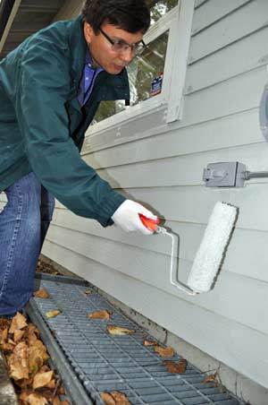 Vladimir Kim of Redmond does some painting at the North Bend-based children’s services nonprofit Encompass on Sept. 21 as part of the Day of Caring sponsored by United Way of King County.