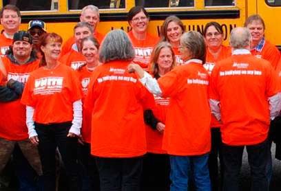 Bus drivers in Lake Washington School District wear Unite Against Bullying T-shirts for Unity Day. Shirts read “No bullying on my bus” on the back.