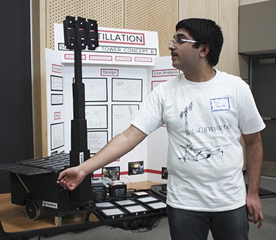 STEM High School student Jay Tayade demonstrates how his team’s solar-powered light tower works to the crowd Wednesday afternoon.