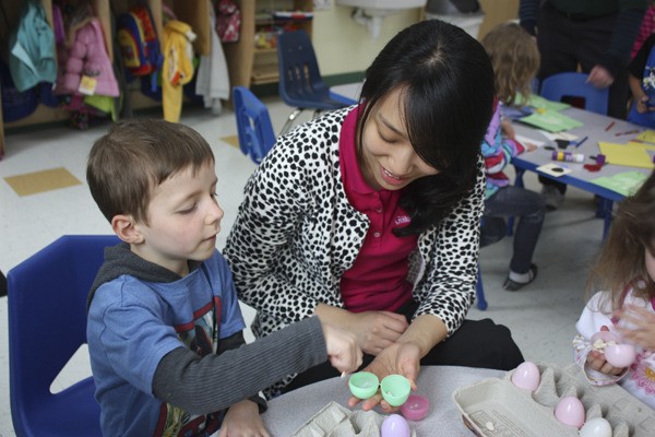 Dylan Begun (left) counts beans with YoonHee Kim at The Goddard School on Redmond Ridge.