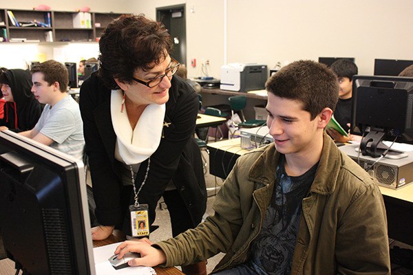 Microsoft IT Academy teacher Grace Brady (left) answers a few of Hugo Baldner’s question during class.