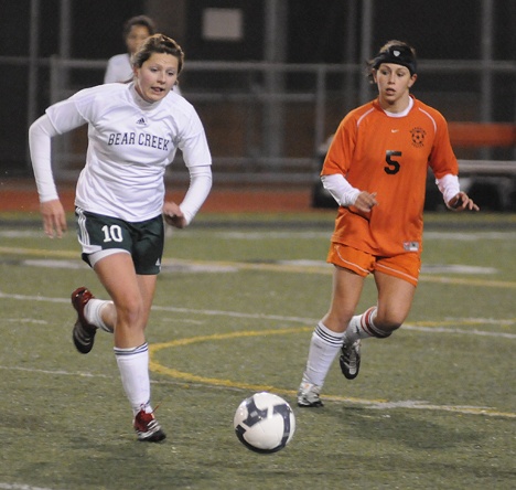 Bear Creek sophomore midfielder Morgan Rial moves the ball upfield as Napavine midfielder Lacey Morris applies some defensive pressure during the Grizzlies' state quarterfinals matchup against the Tigers. Rial scored Bear Creek's only goal as the Grizzlies got edged out 2-1 on a controversial handball call and game-deciding penalty kick.