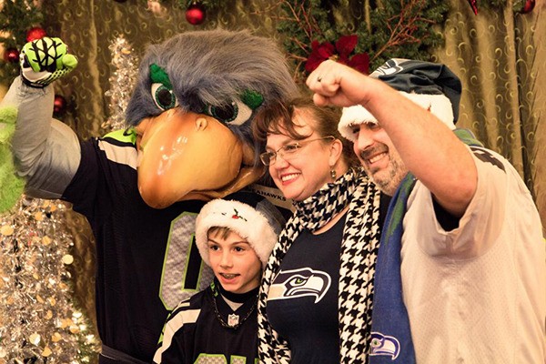 Seattle Seahawks mascot “Blitz” poses with fans last Friday night at the Volume 12 store during Redmond Town Center’s Celebrity Santa Night. “Blitz” took photos with fans