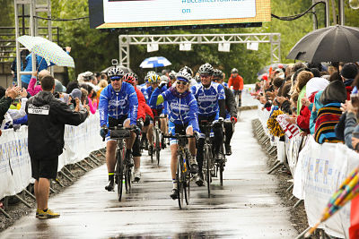 Cyclists cross the finish line at the sixth annual Ride to Conquer Cancer at Redmond's 60 Acres Park south field on Sunday.