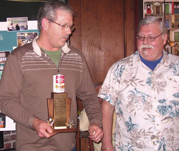 John and Jeff Hancock accept the winner's trophy for Hopelink's March Can Drive this year. This is the third year in a row the Redmond bakery has won the competition.