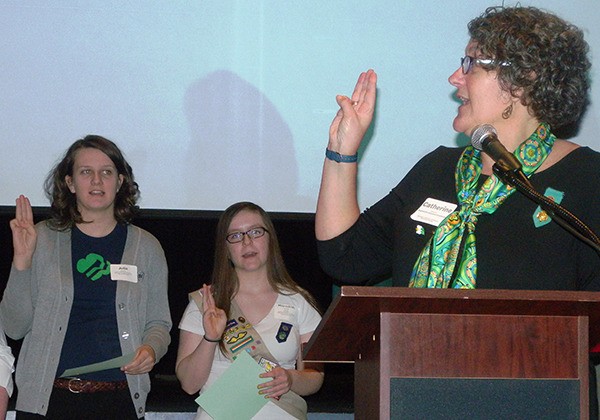 Julia Doherty (left) being sworn in as a national council delegate for Girl Scouts of Western Washington by chair Catherine Gelband at the 2014 Annual Meeting on Feb. 8.