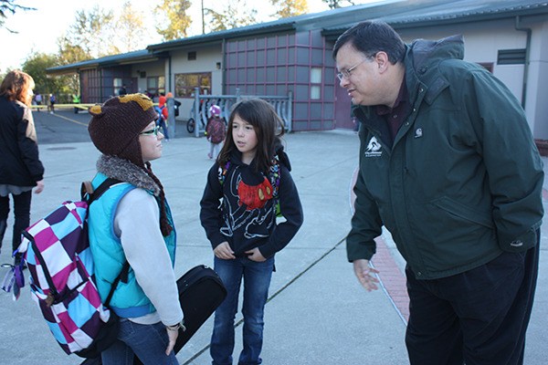 Redmond Mayor John Marchione (right) speaks with Albert Einstein Elementary School students Sophie Williams and Maren MacDonald Wednesday morning.