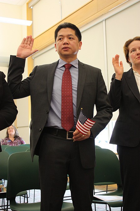 Redmond’s Arvin Sebastian recites the oath to become a United States citizen on Monday at the Redmond Regional Library.