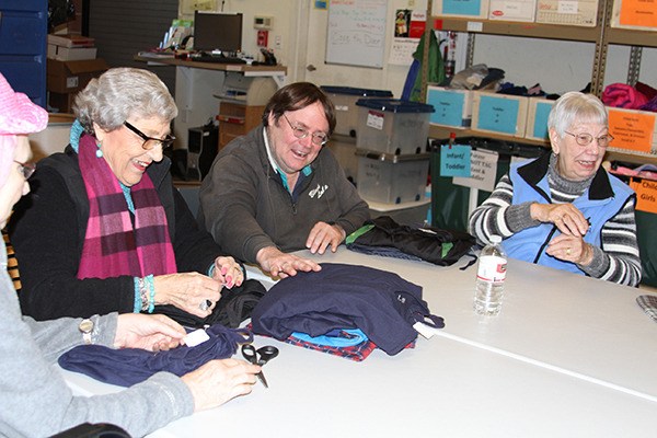 A group of seniors from Fairwinds Redmond sort pajamas to be donated to the Treehouse Wearhouse.