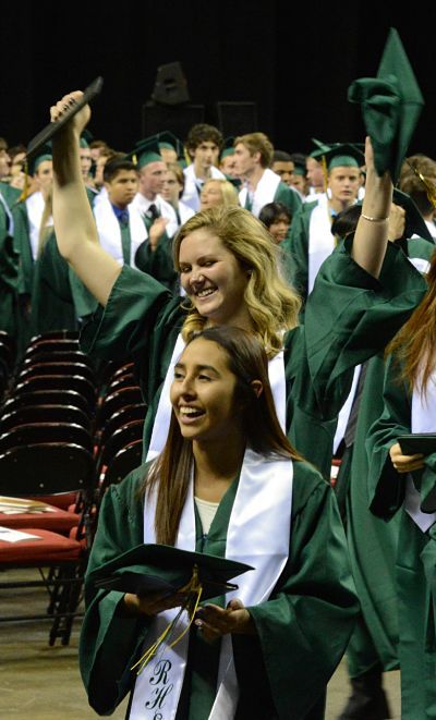 Redmond High School graduates celebrate while exiting KeyArena at the close of this afternoon's ceremony.