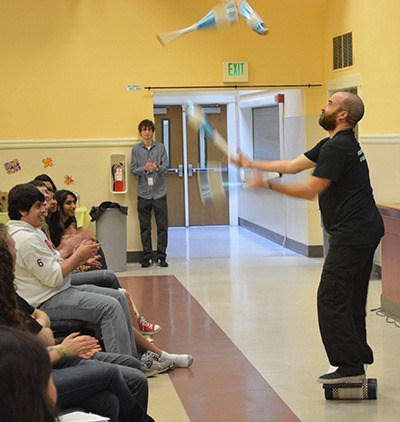 Teens applaud a juggler at the recent youth summit at the Old Redmond Schoolhouse Community Center.