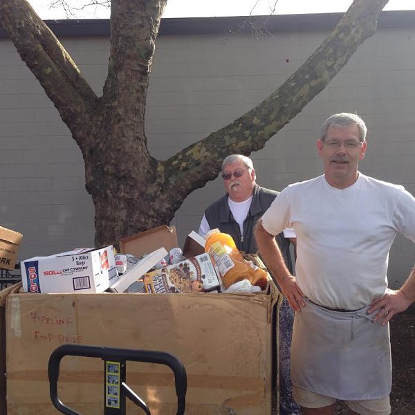 Tournament veterans Jeff and John Hancock unload this week’s Hopelink Can Madness donation. Since the competition began Feb. 29