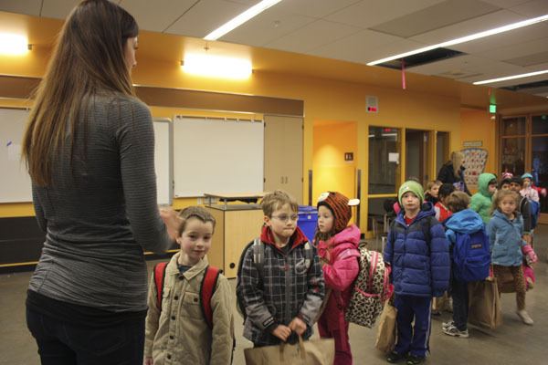 First-grade teacher Michelle Briggs briefly speaks to her students before they enter their new classroom at Ben Rush Elementary.