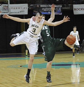 A Northwest Christian (Colbert) player fouls Bear Creek's Jesse Leuenberger toward the end of Thursday night's game. Leuenberger hit his two foul shots to seal the victory.