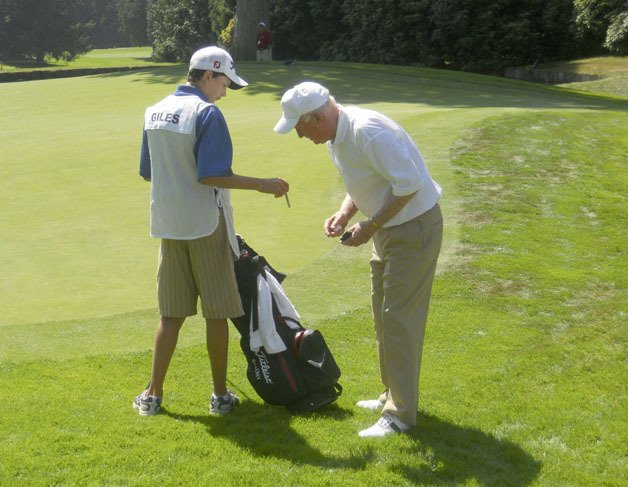 Spencer Weiss (left) was one of a handful caddies from the area selected to carry clubs