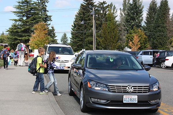 Sam (left) and Bianca Lungu are being picked up by their mother after school at Horace Mann Elementary School.