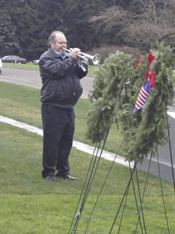 Overlake School band director Steve Mraz performs “Taps” at last Saturday’s Wreaths Across America event.