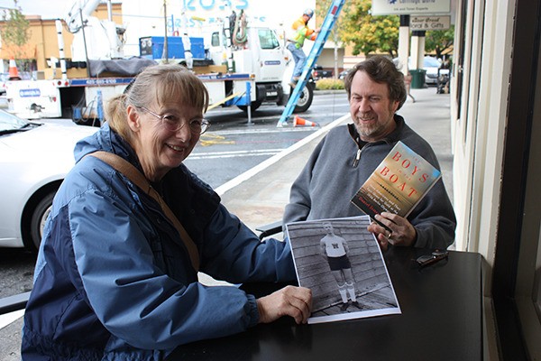 Judy Willman (left) shows off a picture of her father