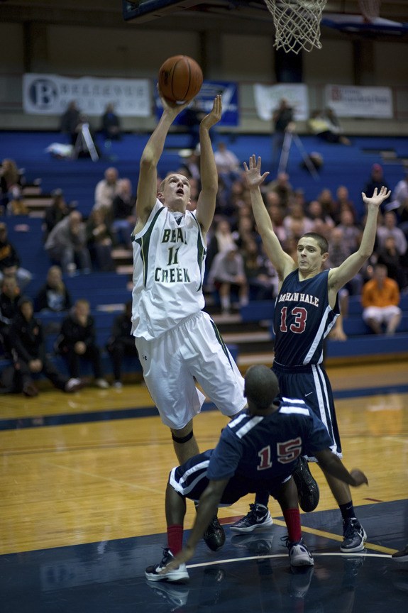 Bear Creek forward Erik Domas plows through two Nathan Hale defenders for two of his 19 points in the Grizzlies' double-OT loss last Friday in the Bellevue College Holiday Tournament. Domas also recorded 15 rebounds for a big double-double.