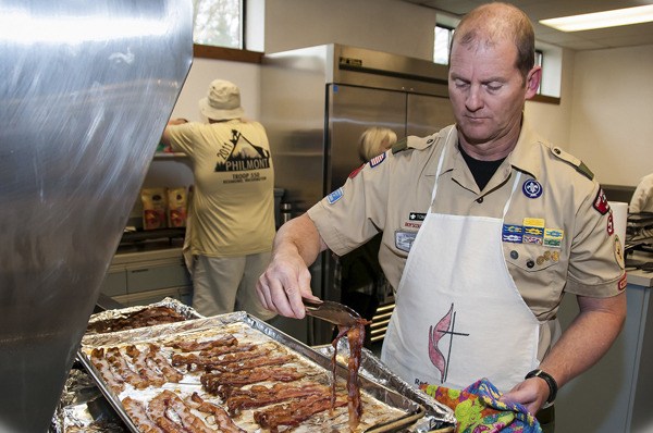 Scoutmaster for Boy Scouts Troop 550 Tom Hobbs prepares some food for Saturday's First Annual Pancake Breakfast for homeless youths at the United Methodist Church.