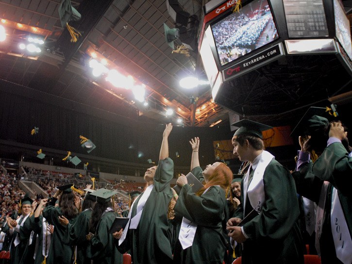 Redmond High graduates throw their hats in the air following Wednesday's commencement ceremony at KeyArena.