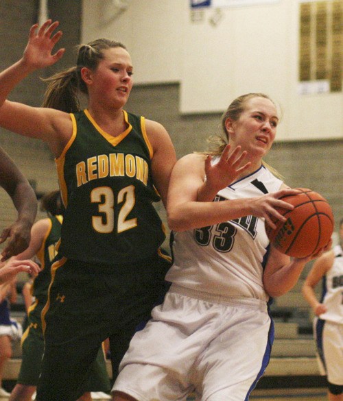 Redmond center Jordyn Ohrt reaches in on a Bothell player during the Mustangs' 65-49 win over Bothell on Monday night. With the win