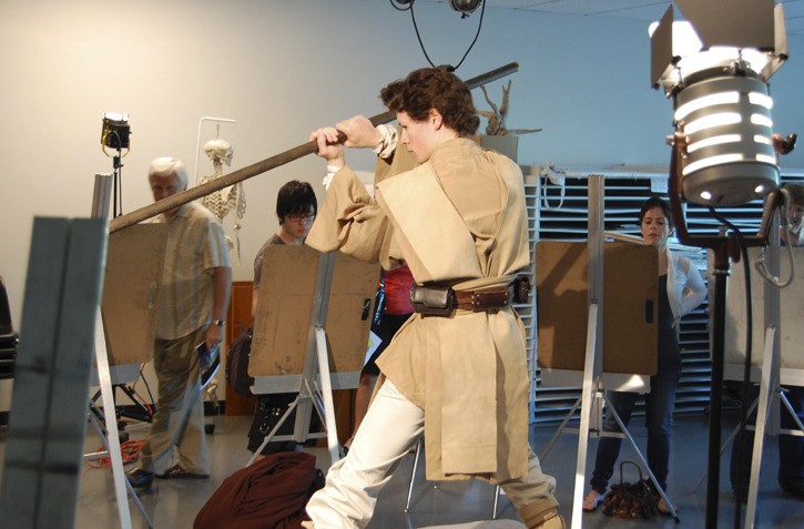 DigiPen student Russell Scott poses as a Jedi from Star Wars while DigiPen Day participants practice their drawing skills. The drawing session was just one of the many events at last Saturday's community event at the DigiPen campus off of Willows Road.