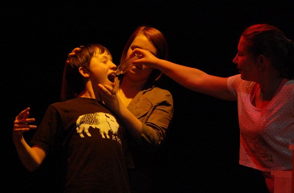 Overlake students rehearse a scene from their upcoming production of 'The Witches.' The Grand High Witch gives a transforming potion to a boy who has interrupted a witch’s convention.