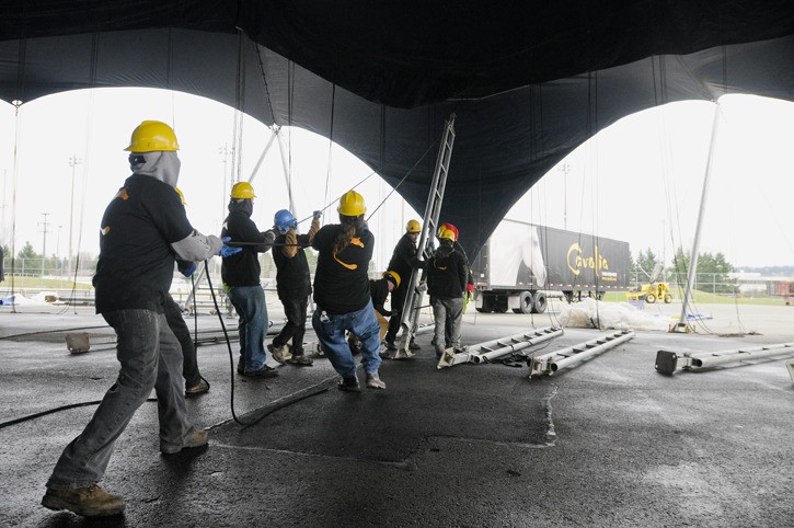 Crew members raise the White Big Top