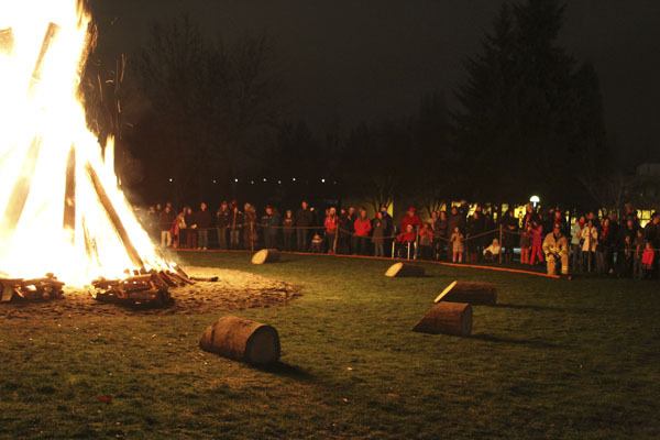 People gather around for a community bonfire Sunday evening at Redmond City Hall. This was the final centennial event to celebrate Redmond's 100th birthday.