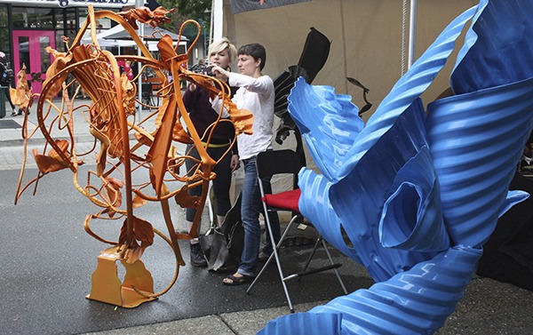 Gina and Irene Yatsenko eye Karsten Boysen's sculpture at last year's Redmond Arts Festival.