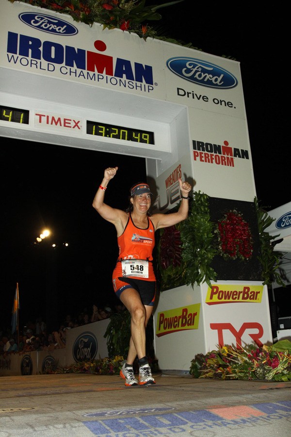 Redmond resident Kathryn Klepinger celebrates after completing the Ford Ironman World Championship race in Kona