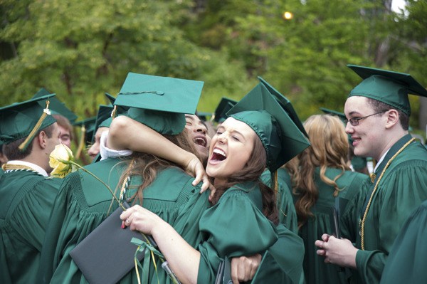 The Bear Creek School graduates Jason Cho and Krisitn Wallis and Elizabeth Fernandez embrace in a hug following Saturday's commencement ceremony at the First Presbyterian Church of Bellevue.