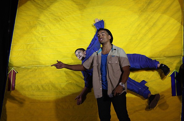 Eighth-grader Isaiah Fahrenkopf (back) hangs out on a Velcro wall as John “J.J.” James explains Isaac Newton’s first law of motion