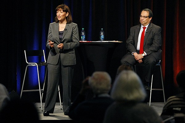 Suzan DelBene and Pedro Celis engage in a debate on Wednesday at Microsoft Corp. in Redmond.