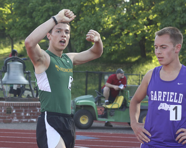 Redmond High’s Johnathan Stevens raises his arms in victory after placing first in the 1