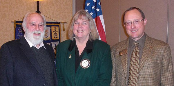 New Poet's Society Executive Director Rick Smith  (left) and Together Center Executive Director Pam Mauk (center) recently received grants for their organizations from the Rotary Club of Redmond. Rotary President Steve Bozick presented them with their checks.