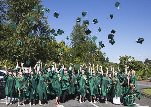 The Bear Creek School Class of 2015 graduates toss their caps following Sunday's commencement.