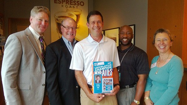 Sen. Andy Hill (center) is presented with the Legislative Champion Award by members of the Children's Alliance.