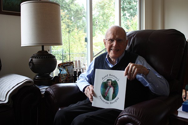 Bud Barnard holds up a copy of “Aunt Bunny’s Favorite Recipes