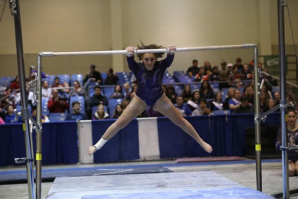 Sixteen-year-old Megan Phillips performs her uneven bars routine at the Washington state gymnastics competition in February. Phillips was almost unable to compete due to a sprained ankle but got healthy just in time.