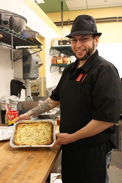 Ian Beck displays his savory bread pudding in The Three Lions Pub kitchen on Redmond Ridge.